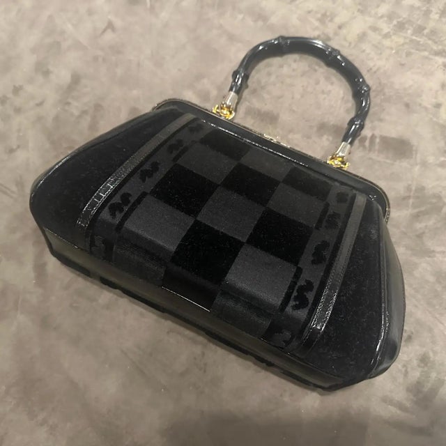 This exquisite black handbag is a rare find from the 1940s, embodying the sophisticated, structured glamour of Italian...