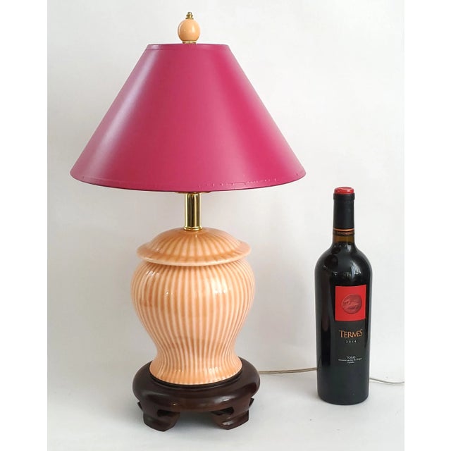 Offering a SMALL Chinese ginger jar table lamp with wood base and vintage magenta cardboard shade, circa 1980s. This...