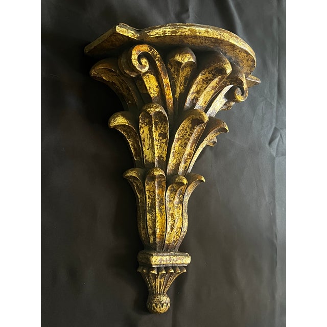 Extra large acanthus wall bracket with antiqued gold gilt finish with holes for hanging. Measures 13.5” wide, 7” deep and...