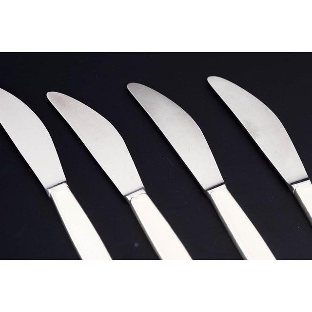 Georg Jensen, set of four lunch knives, Cypress. Set of four lunch knives in stainless steel and sterling silver in the...