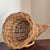 Offering a beautiful French Country-style cornucopia basket. This lovely handwoven footed basket features pretty French...