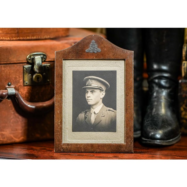 This is an original World War I era, framed portrait photograph of a young man in British military uniform. The portrait...