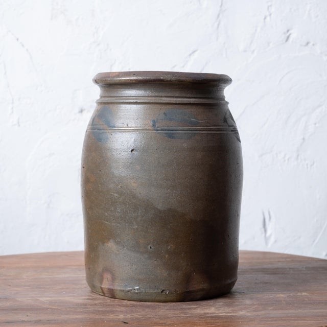 A Virginia stoneware crock with blue slip. 7 ½ inches wide by 9 ¾ inches tall