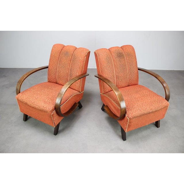 Rare pair of 1930s Czechoslovak armchairs attributed to Jindřich Halabala, featuring beautifully curved wooden armrests...