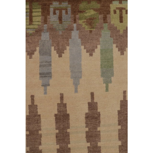 This contemporary 7x10 Scandinavian rug, hand-knotted in wool, features a rhythmic geometric design in earthy beige,...