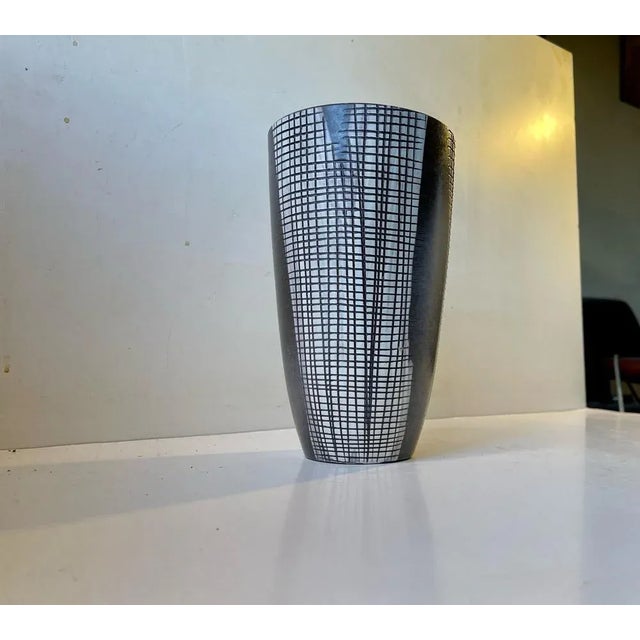 A rare vase by mari simmulson for upsala-ekeby. A modern stylish design. Partially glazed stoneware with incised squares/...
