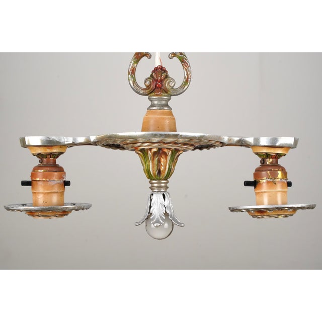 This is a delightful Victorian-inspired bare-bulb chandelier dating from the mid-20th century. It is a prime example of...