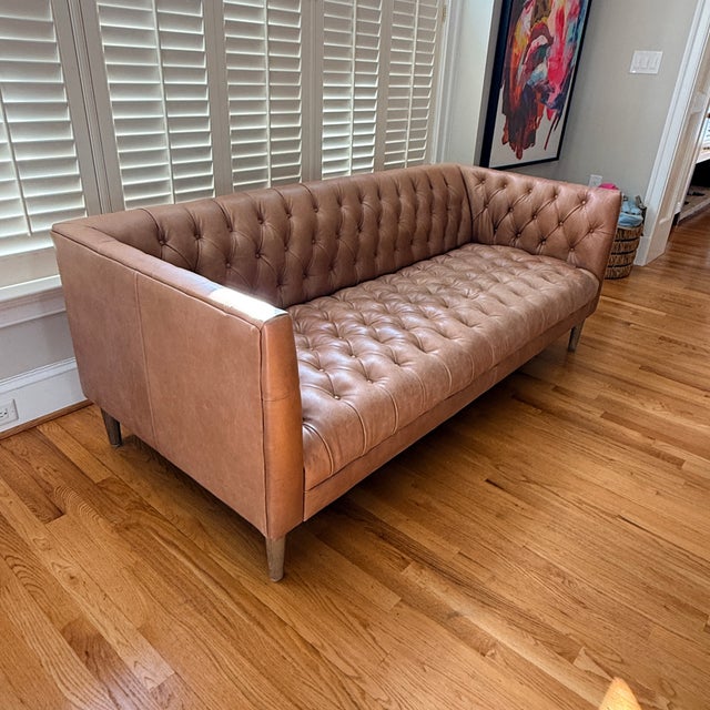 Crate & Barrel Rollins Leather Sofa Luxurious top-grain leather brings a clubby feel to this mid-century inspired Rollins...