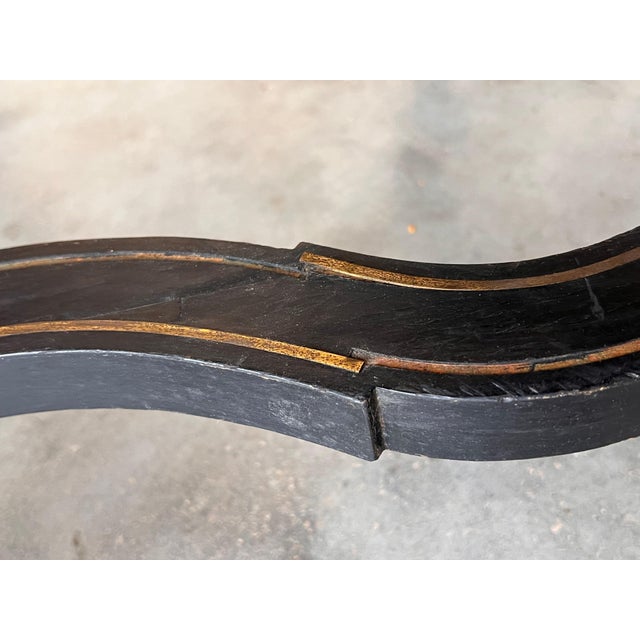 An imposing Napoleon III center table (or 'Table de Milieu') in ebonized fruit wood, rectangular in shape, with rounded...