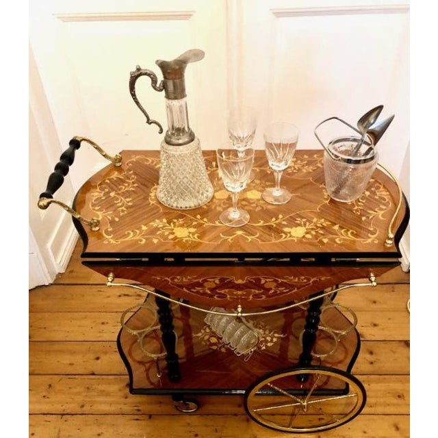 Elegant, high-quality vintage luxury serving trolley with inlays and brass embellishments, polished to a high gloss with...