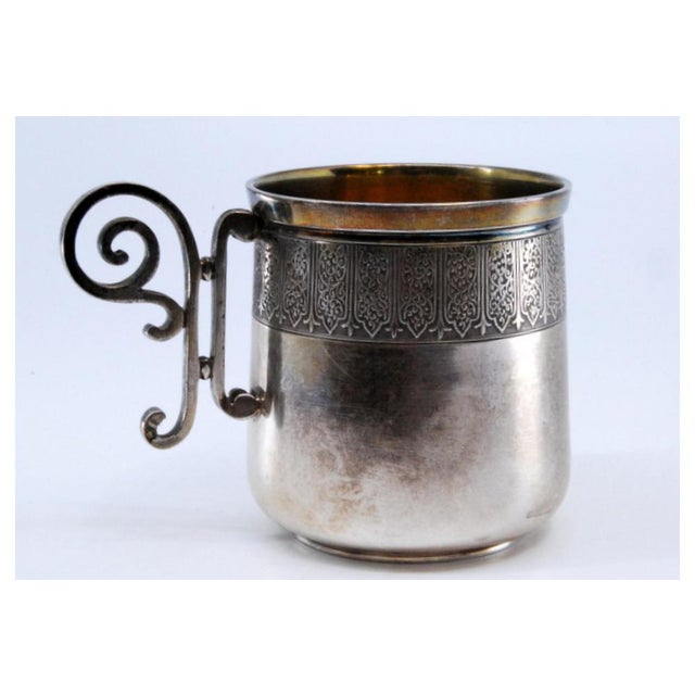 Silver Cup with Scrolls Handle and Relief Rim, in Very Good conditions. Designed before 1890 This piece has an attribution...