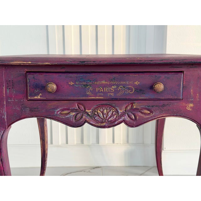 This unique French-style accent table has been entirely hand-painted and artistically aged in a deep Bordeaux wine tone,...