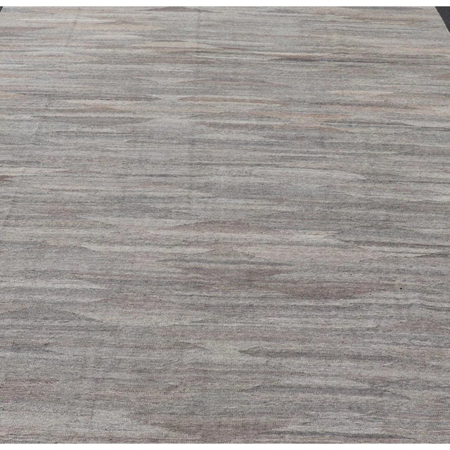Measures: 9'0 x 11'8. This flat-weave kilim has been hand-woven. The rug features a modern diamond design, rendered in...