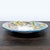 The plate features a hand-painted floral design with vibrant colors and a blue rim. Brand: Rampini Radda Ceramics....