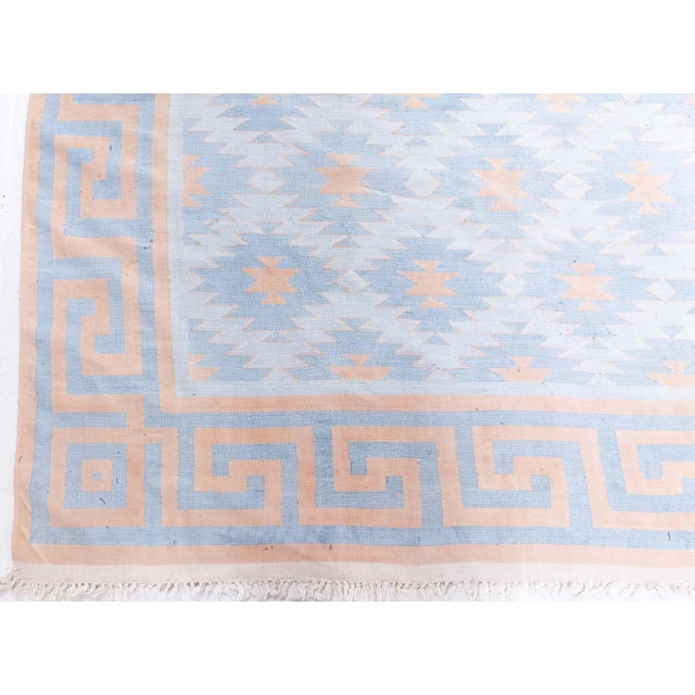 Bold yet soft, this vintage Indian Dhurrie rug presents a striking interplay of geometric design and light tones....