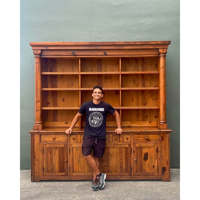 This magnificent "Bromley" hutch from Ralph Lauren Home is a masterclass in rustic elegance, drawing inspiration from the...