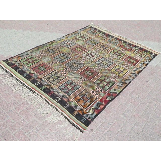 This beautiful, traditional vintage, flatweaved Turkish kilim rug is approximately 60 years old. It is handmade of very...
