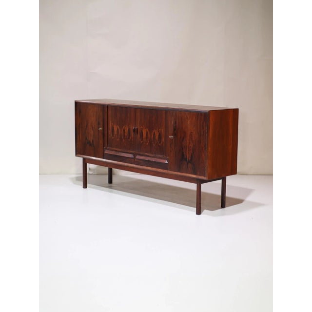 Beautiful vintage sideboard from Denmark, 1960s, a rare kingwood highboard featuring a striking, expressive grain pattern....