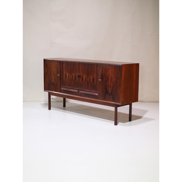 Beautiful vintage sideboard from Denmark, 1960s, a rare rosewood highboard featuring a striking, expressive grain pattern....