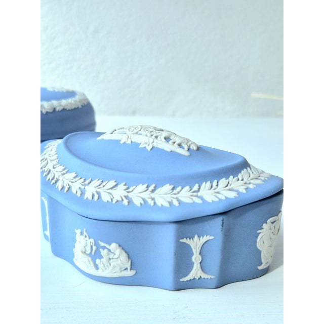 An authentic mid-20th-century oval lidded trinket box in signature pale blue jasperware by wedgwood. The lid features a...