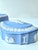 An authentic mid-20th-century oval lidded trinket box in signature pale blue jasperware by wedgwood. The lid features a...