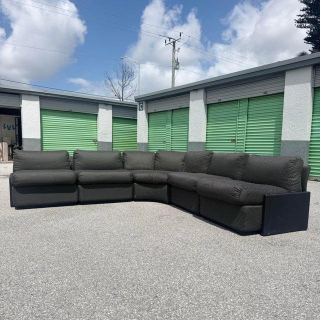 A striking Postmodern modular sectional sofa, executed in a sophisticated black-on-black palette that emphasizes both form...