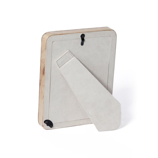 Crafted with an artful burl veneer and gently rounded edges, this tabletop photo frame brings warmth and organic texture...