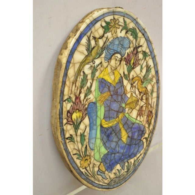 Early 20th Century Antique Persian Iznik Qajar Style Ceramic Pottery Oval Tile Figure With Bird C3 For Sale - Image 5 of 9