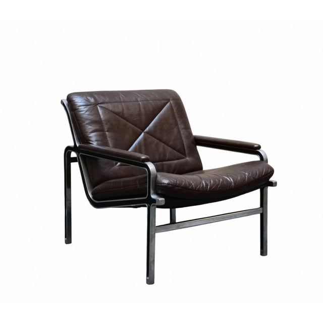 High-quality, elegantly designed armchair, manufactured by Strässle International in the 1960s, in cast aluminum and brown...
