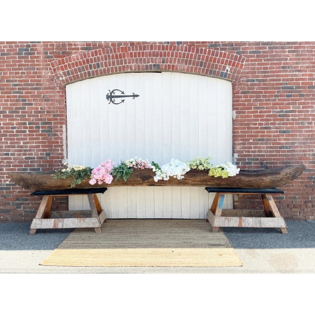 An exceptional early 20th century antique wooden canoe crafted from a single tree trunk through primitive construction...