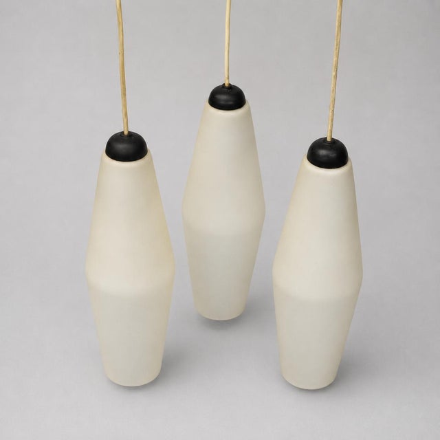 Vintage pendant lamp set of 3 – matte white glass with black shade Bring a timeless mid-century modern atmosphere into...
