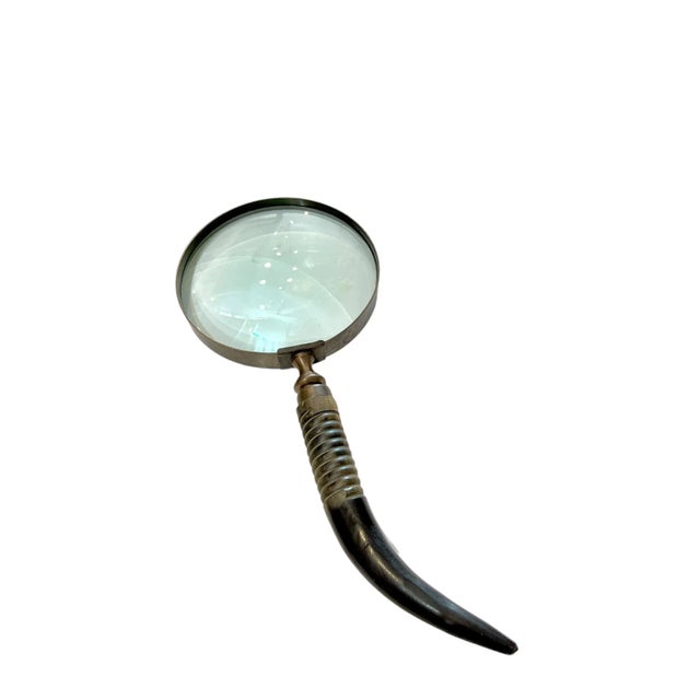Large size brass magnifying glass with horn and carved wood handle. Great size for a coffee table accent.