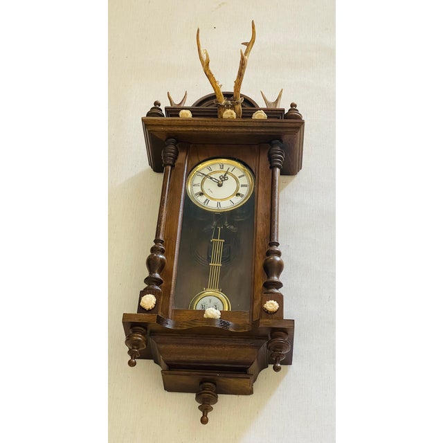 Antique Herman Bkack Forest wall pendulum clock with deer antlers, antler tips and borrows. White enamel face clock...