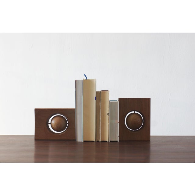 A pair of wooden bookends with a geometric, sculptural form characteristic of mid-20th-century modernist design. Each...