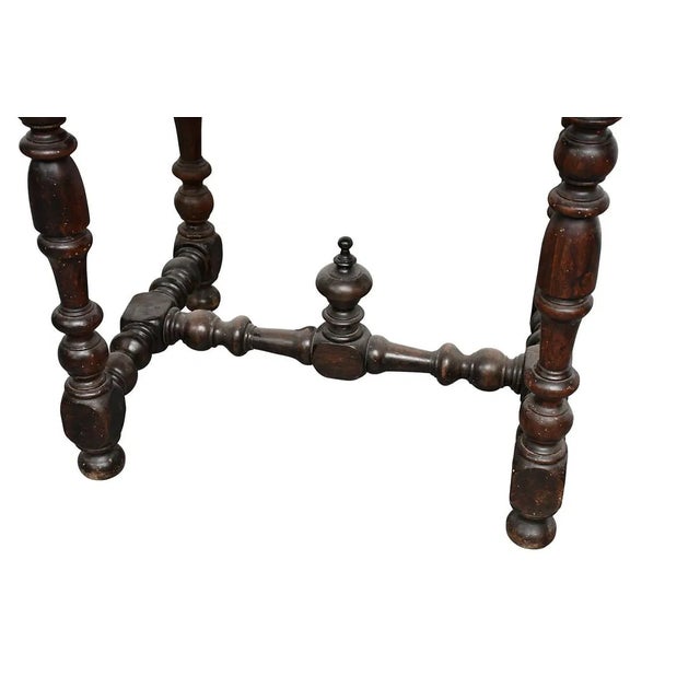 This 1800s Spanish Antique Kitchen Oval Table is a beautifully crafted piece with a rich brown wood tabletop and a classic...