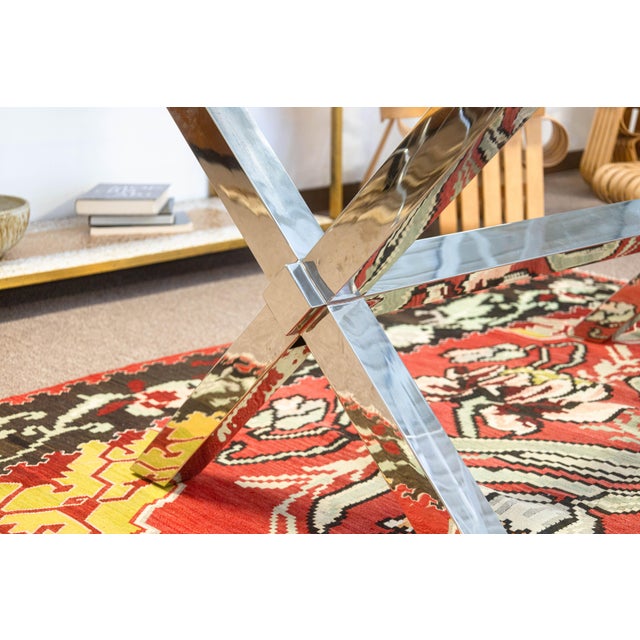 A contemporary modern chrome and glass dining room table. This is a lovely, chic dining room table featuring a large...