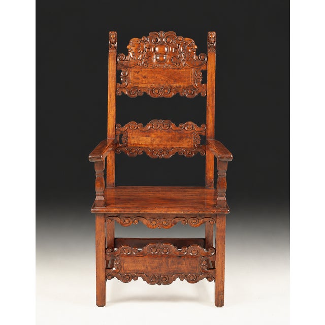 Antique Italian Baroque armchair handcrafted from solid walnut and richly decorated with hand-carved details throughout....