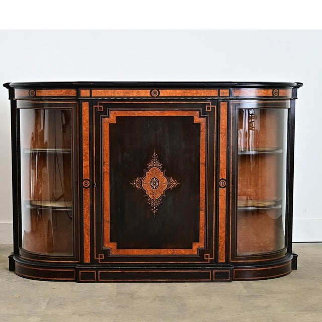 A spectacular cabinet/credenza from England circa 1850, displaying many of the audacious characteristics as the Third...