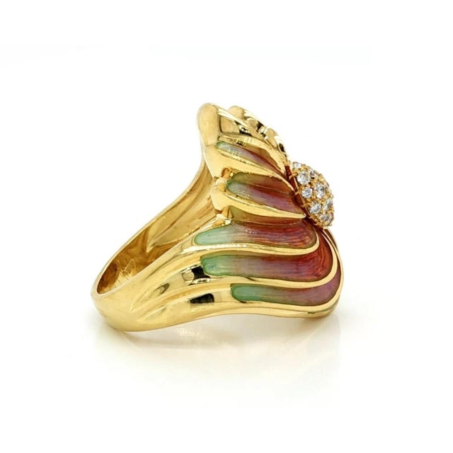 This authentic cocktail ring is crafted in solid 18k yellow gold and showcases a bold swirl floral design accented with...