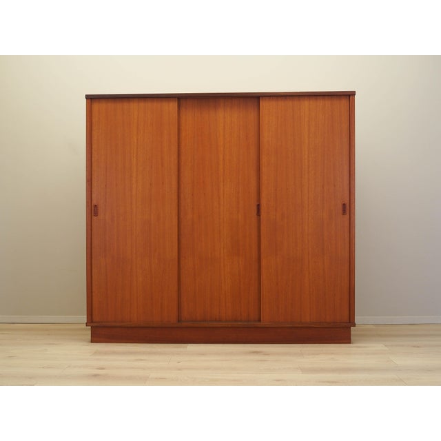 The wardrobe was made in the 1960s in Denmark. The structure is covered with teak veneer. The surface has been refreshed....