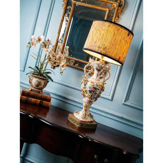 A beautifully detailed vintage Italian Capodimonte style porcelain amphora urn table lamp featuring hand-painted floral...