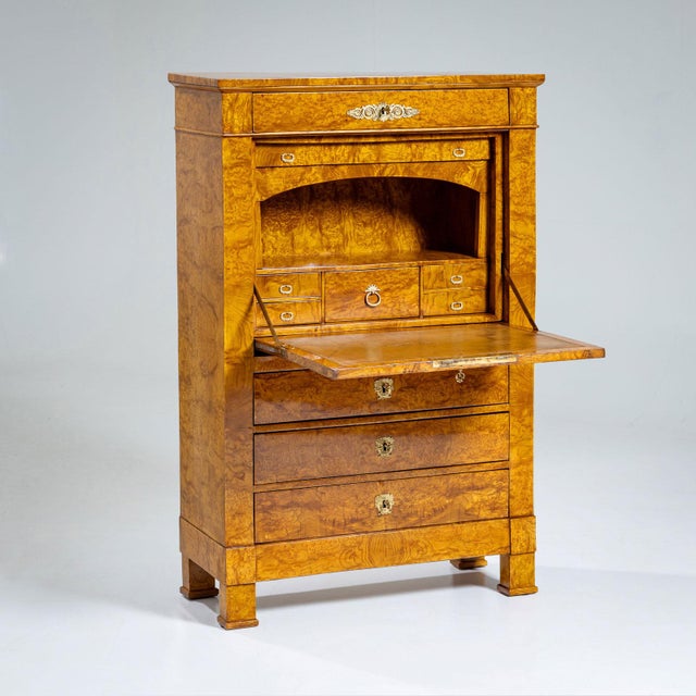 Secretary desk with exquisite ash veneer and a three-drawer commode base. Behind the leather-covered writing surface lies...