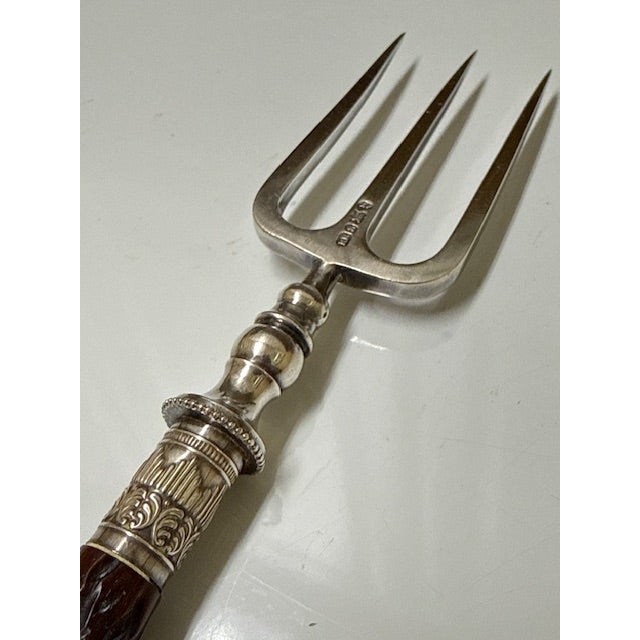 This exquisite Sterling silver toast fork with bone handle antique cutlery item, likely dating to the early 19th century....