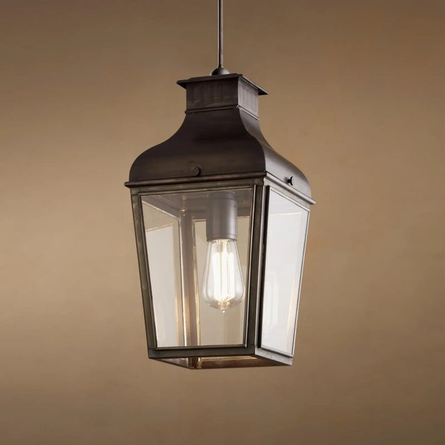 Hanging light with pagoda structure in dark bronze with outside fitted clear glass. For indoor and outdoor use (IP43)....