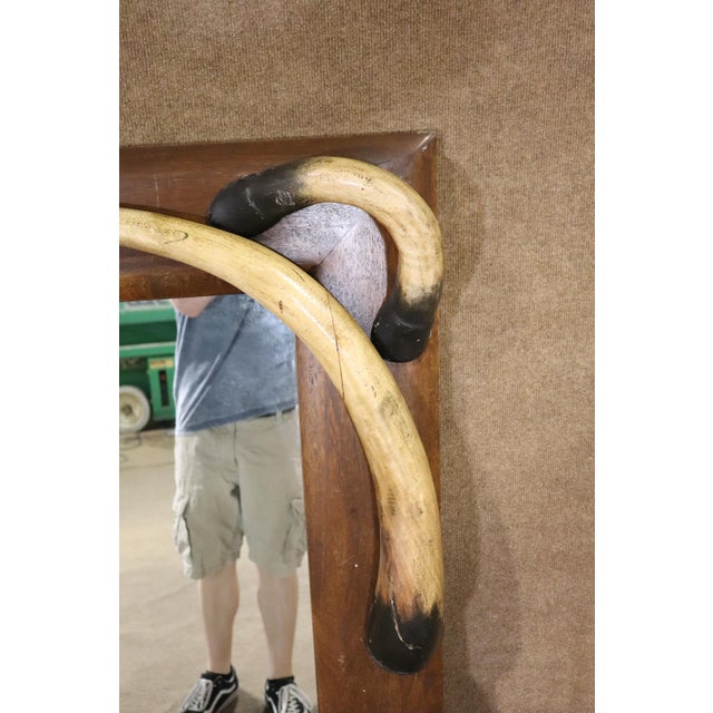 Large mirror with faux horns around the frame give this a great rustic look.