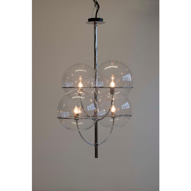 Lyndon by Vico Magistretti for Oluce; chrome-plated finished candelabra-style body, enclose transparent glass spheres,...