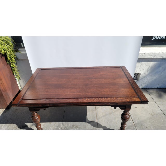 A large Oak Jacobean Tudor Spanish Revival Dining Table. Draw leaves pull out from sides. 62 x 38 closed 96 x 38 open....