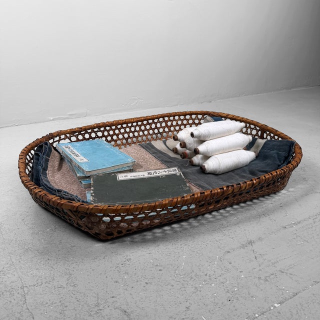 Japanese bamboo basket, dating from circa 1950–1960, Shōwa period, Japan. The basket is handwoven in an open pattern and...
