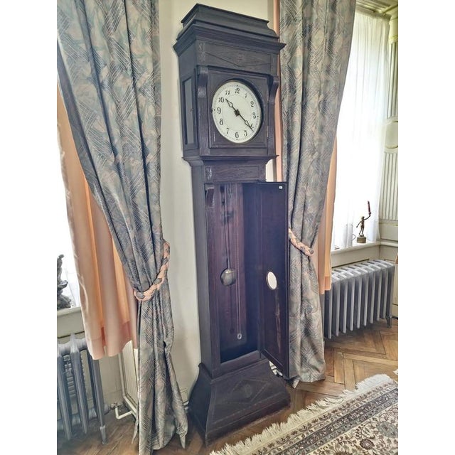 The clock body is made of solid oak. The dial is made of glass with a brass frame. The clock mechanism is on chains. The...