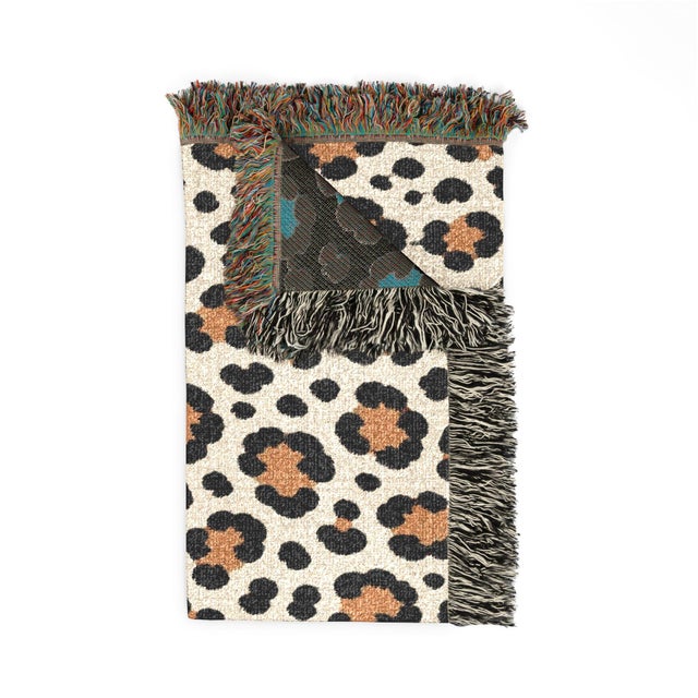 This leopard print woven throw blanket features oversized black and warm camel tan spots on cream, finished with...